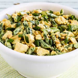 Square image for Curried Chicken Salad with Asparagus and Pine Nuts shown in white bowl.