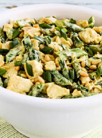 Square image for Curried Chicken Salad with Asparagus and Pine Nuts shown in white bowl.