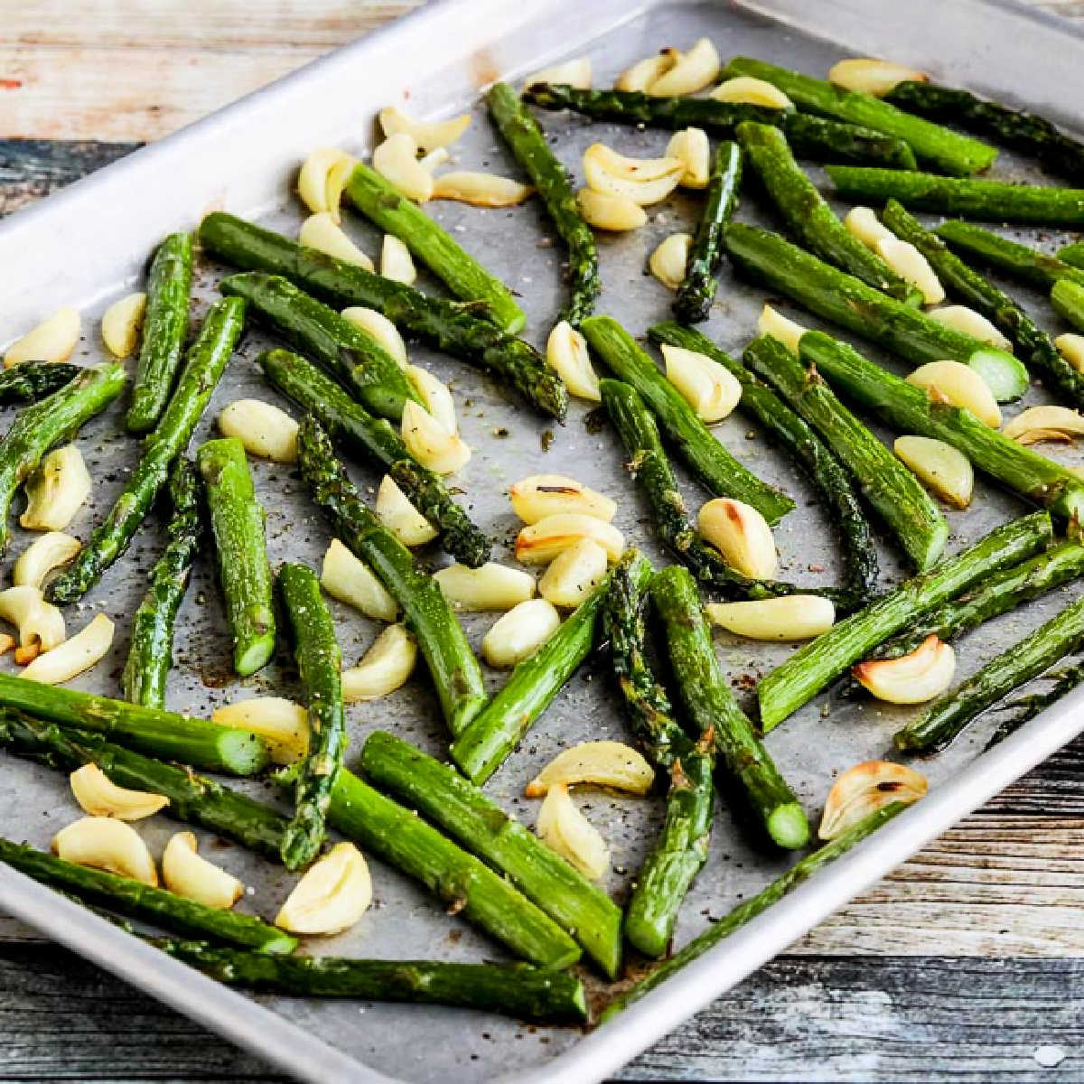 Square image of Roasted Asparagus with Garlic on sheet pan.