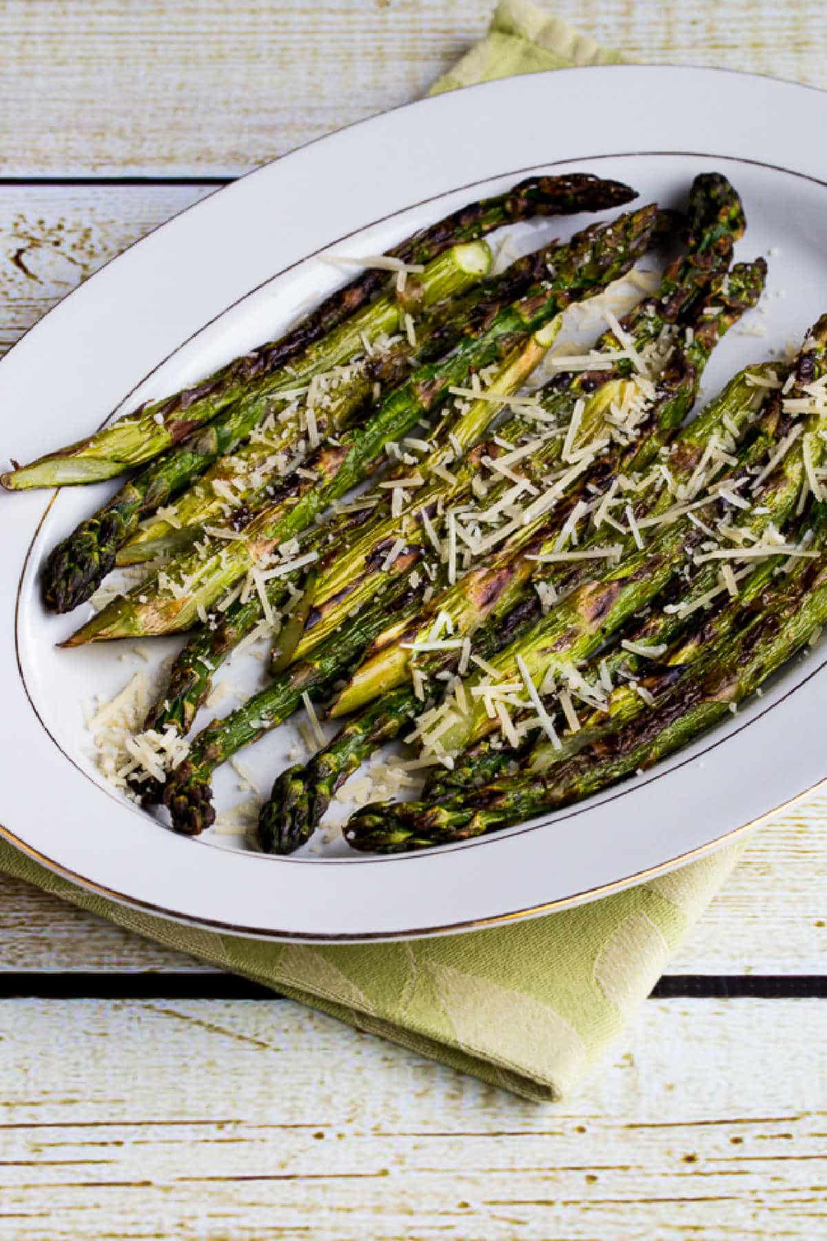 Grilled Asparagus with Parmesan shown on serving dish placed on napkin