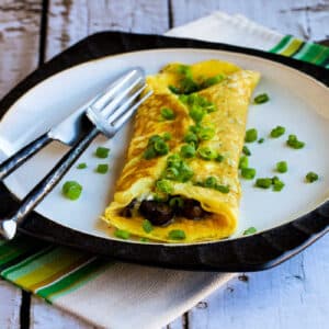 square image of Omelet with Mushrooms and Goat Cheese shown on serving plate