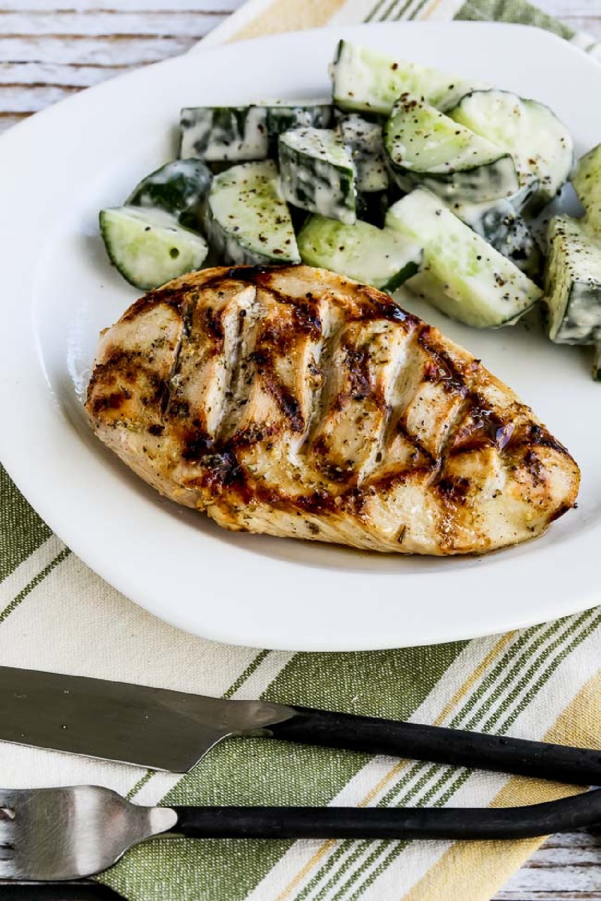 Very Greek Grilled Chicken on serving plate with cucumber salad