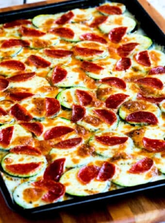 Square image of Broiled Zucchini with Mozzarella and Pepperoni shown on baking sheet.