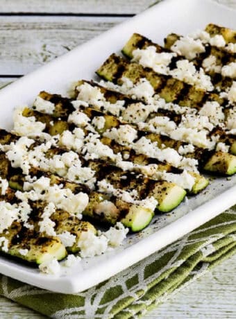 Square image of Easy Grilled Greek Zucchini on serving plate.