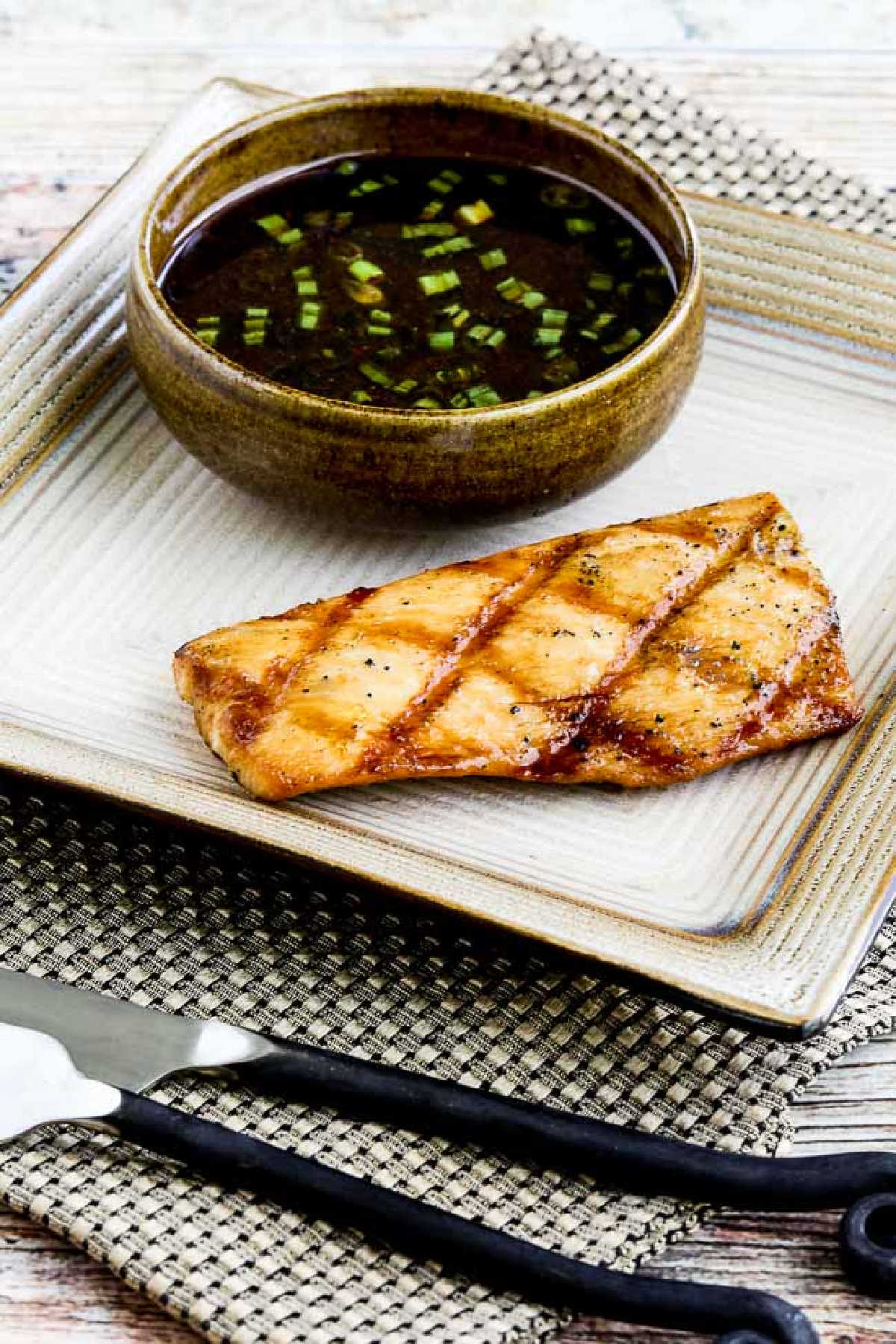 Grilled Mahi Mahi with Korean Dipping Sauce shown on serving plate with sauce