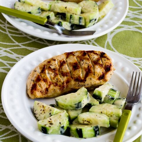 close-up shot of Completely Foolproof 100% Delicious Grilled Chicken finished chicken on plate with Cucumbers Caesar
