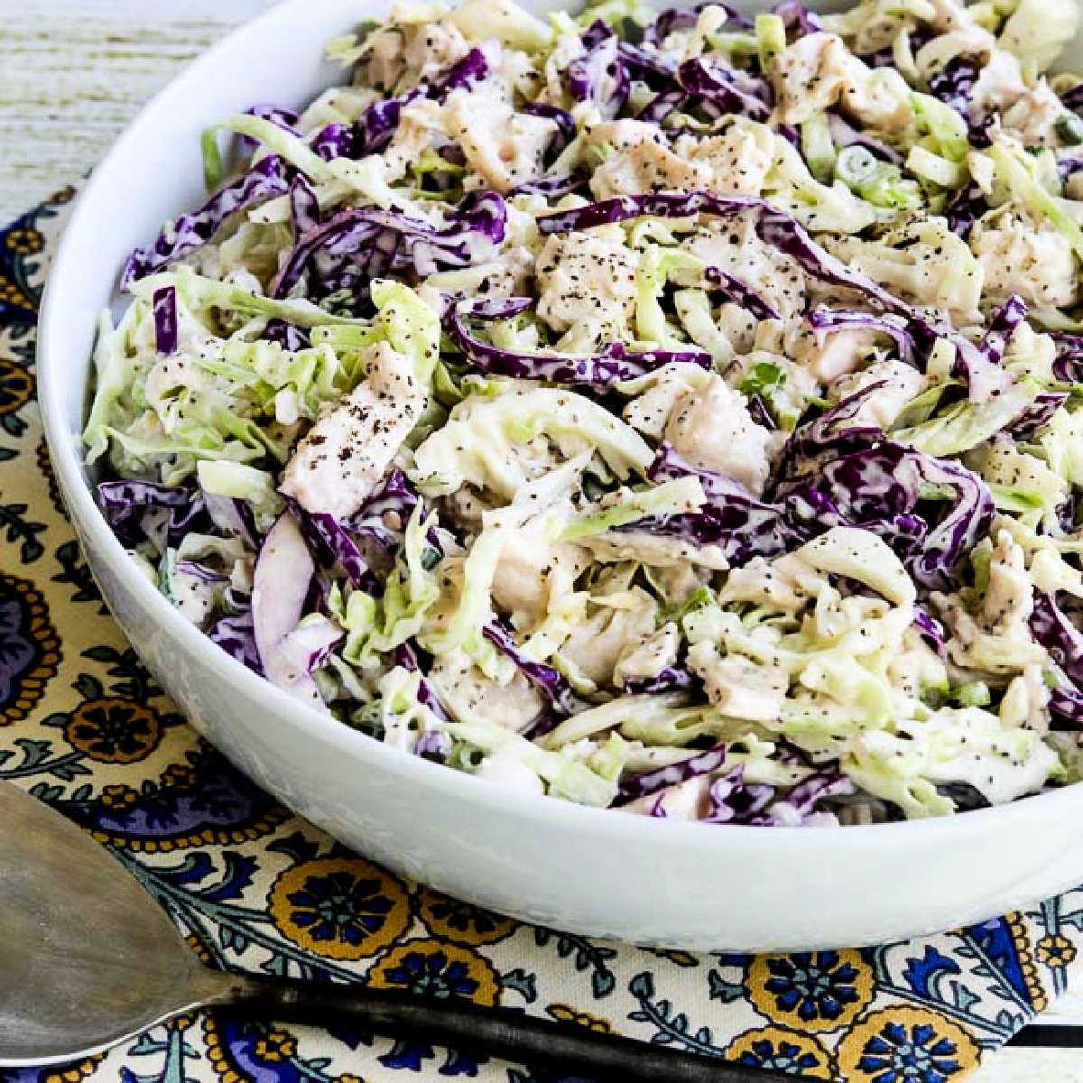 Square image of Chicken Cabbage Salad with Mustard shown on napkin.