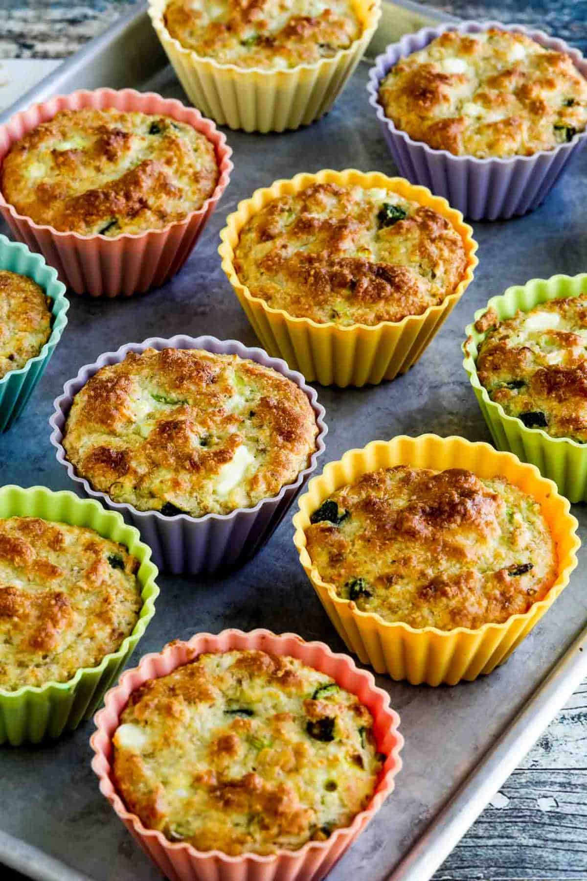 Flourless Breakfast Muffins with Zucchini and Feta shown on baking sheet in silicone muffin cups