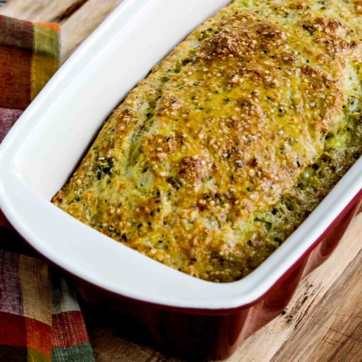 Savory Almond Flour Bread shown in crockery bread pan on cutting board