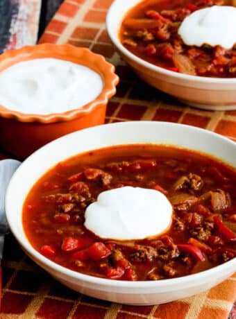 Square image for Instant Pot Goulash Soup shown in two serving bowls with sour cream.