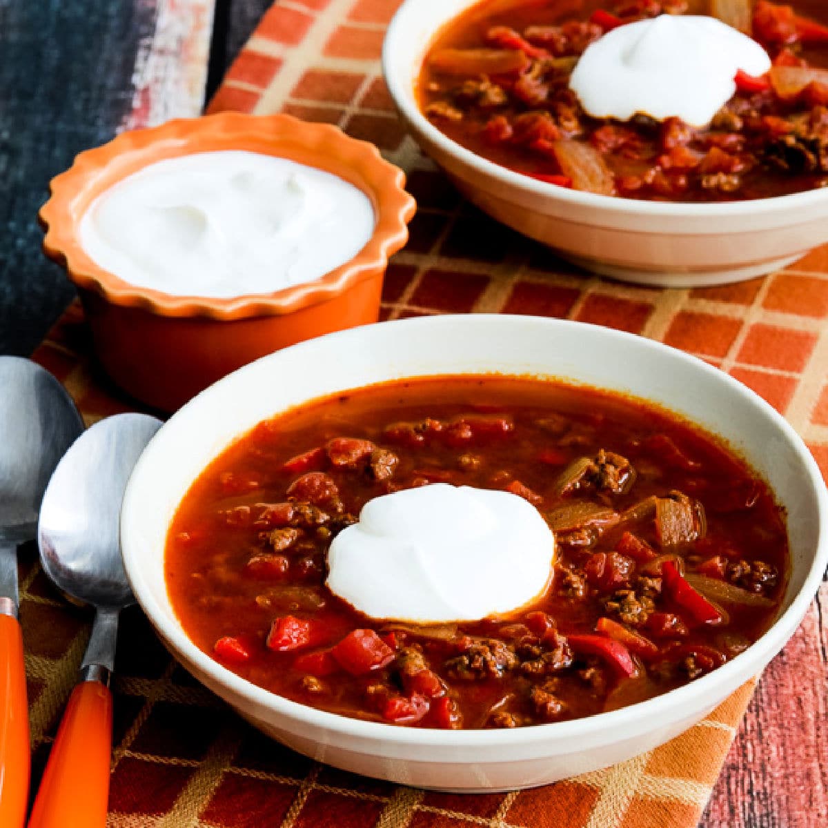 Square image for Instant Pot Goulash Soup shown in two serving bowls with sour cream.
