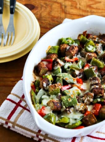 Square image of Low-Carb No-Egg Breakfast Bake with Sausage and Peppers in baking dish with plates, forks.