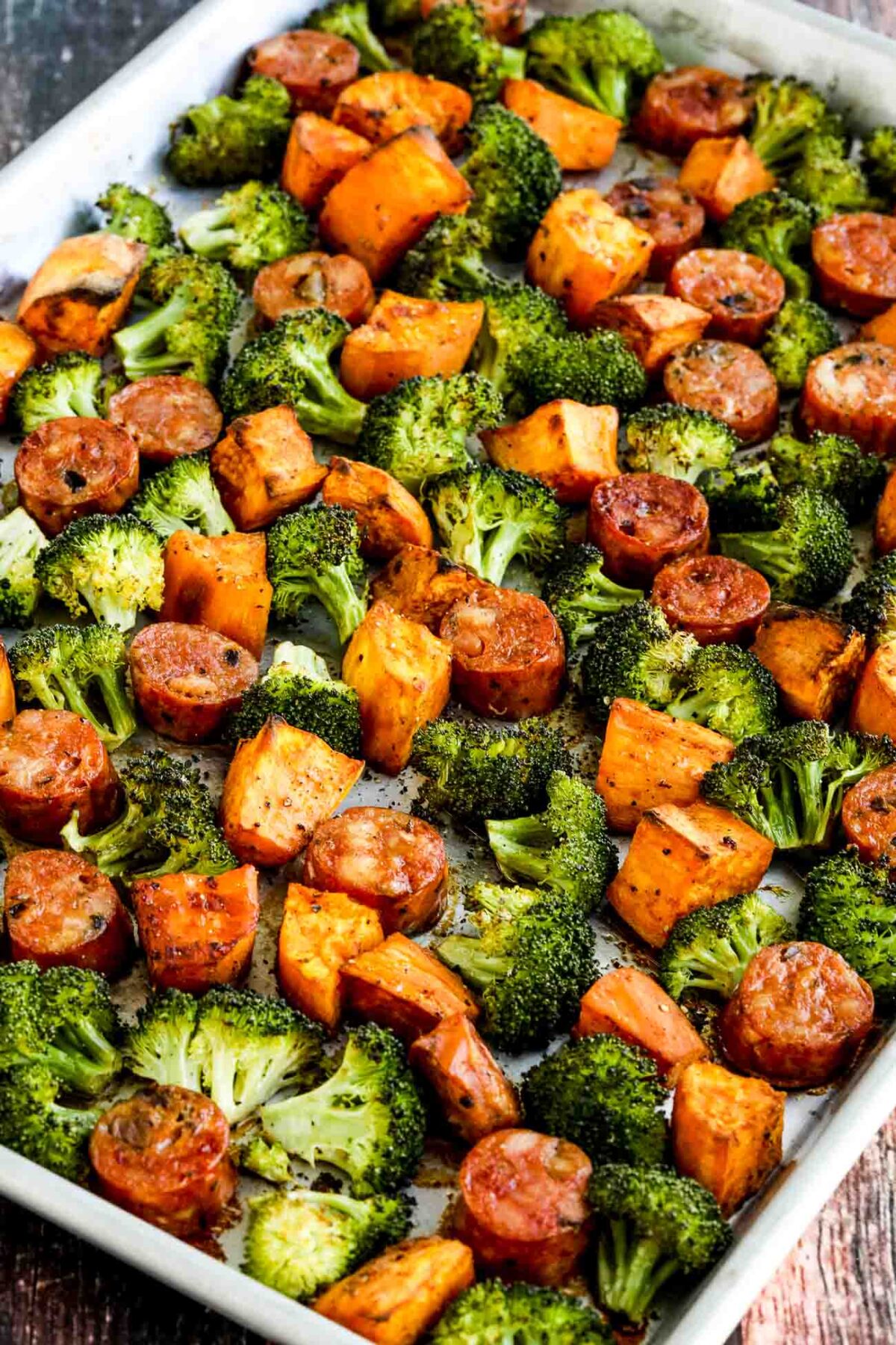 Roasted Sweet Potatoes, Sausage, and Broccoli Sheet Pan Meal shown on sheet pan after roasting