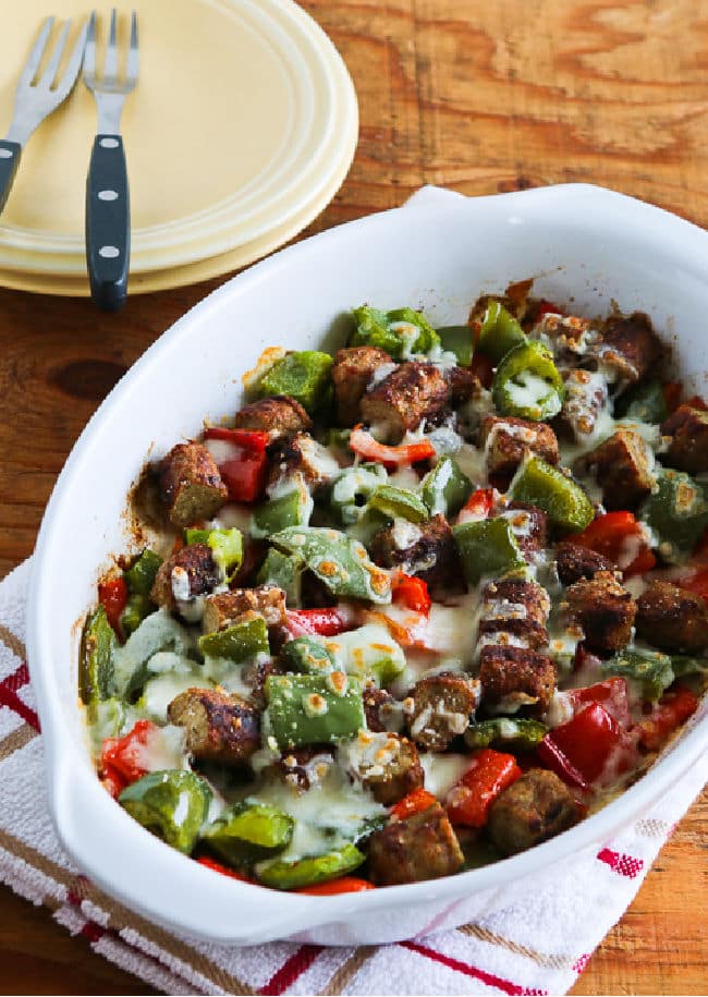 Low-Carb No-Egg Breakfast Bake with Sausage and Peppers in baking dish with plates, forks.