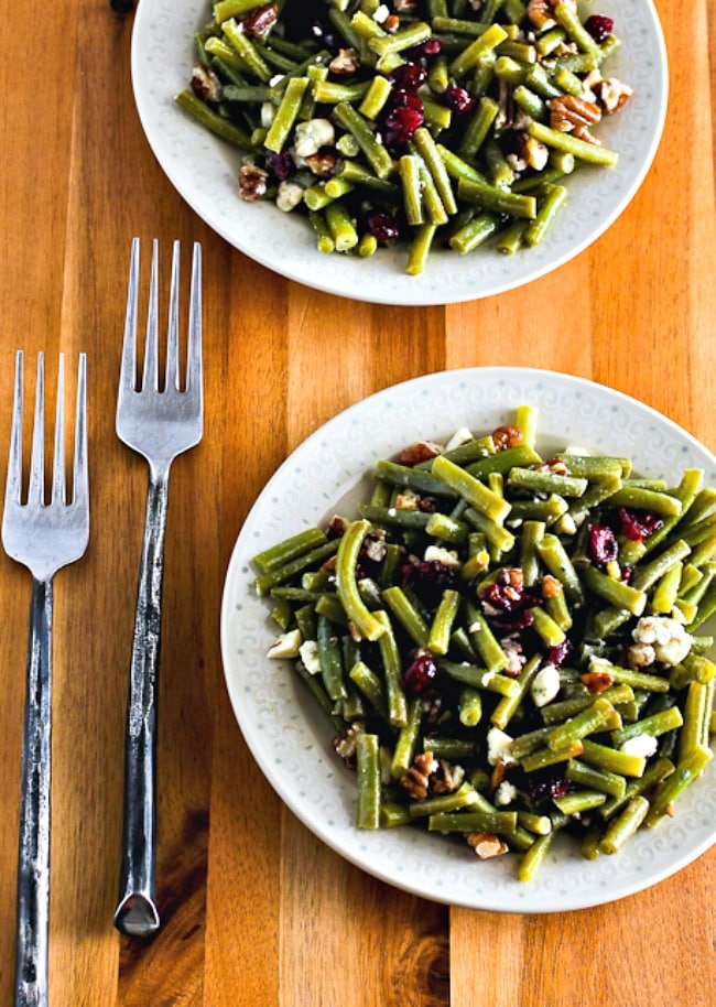 Thanksgiving green bean salad on two plates with forks