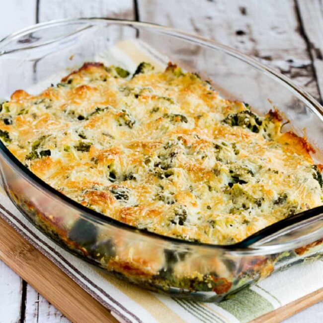 Broccoli Gratin in baking dish on napkin and cutting board.