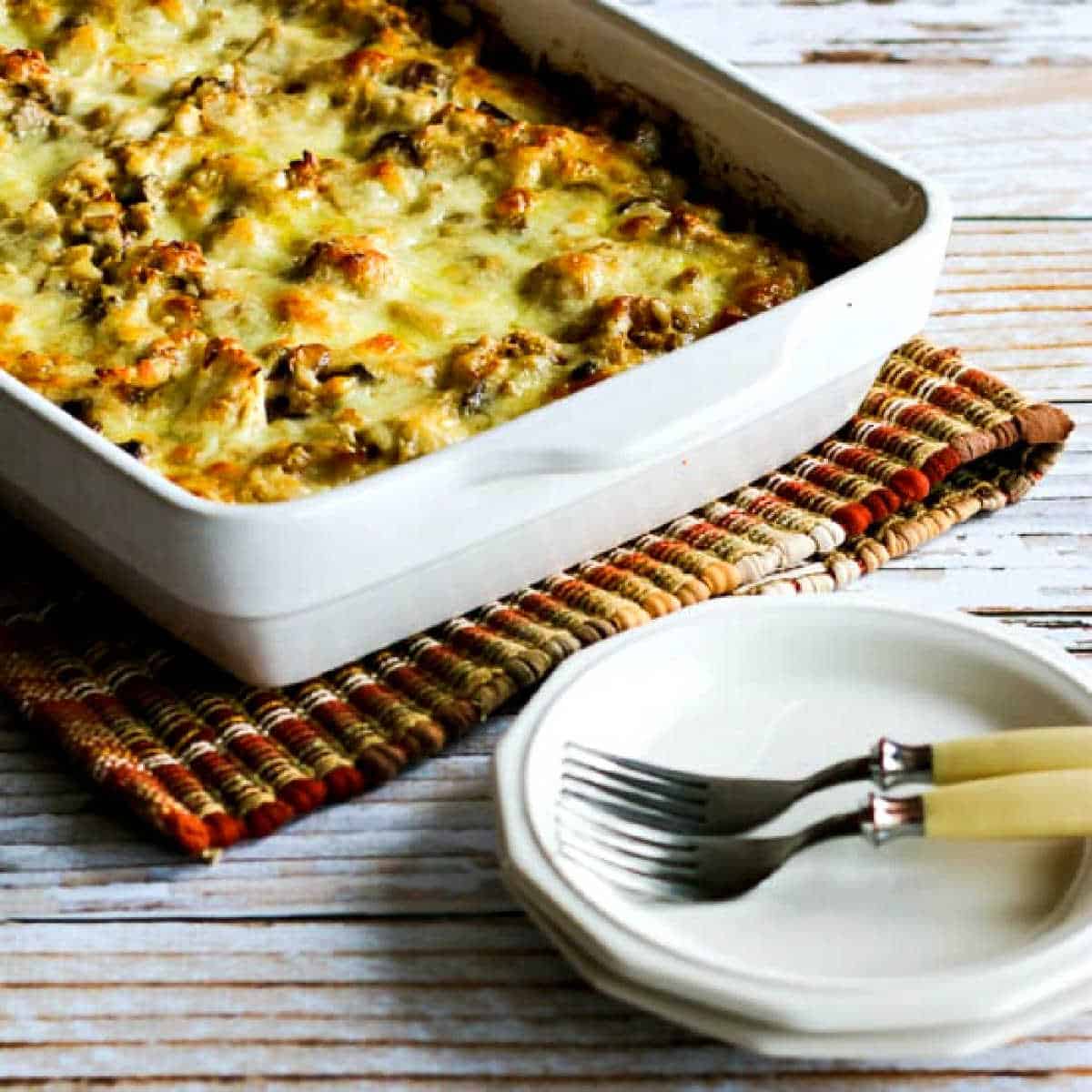 Low-Carb Turkey Casserole in baking dish with plates, forks