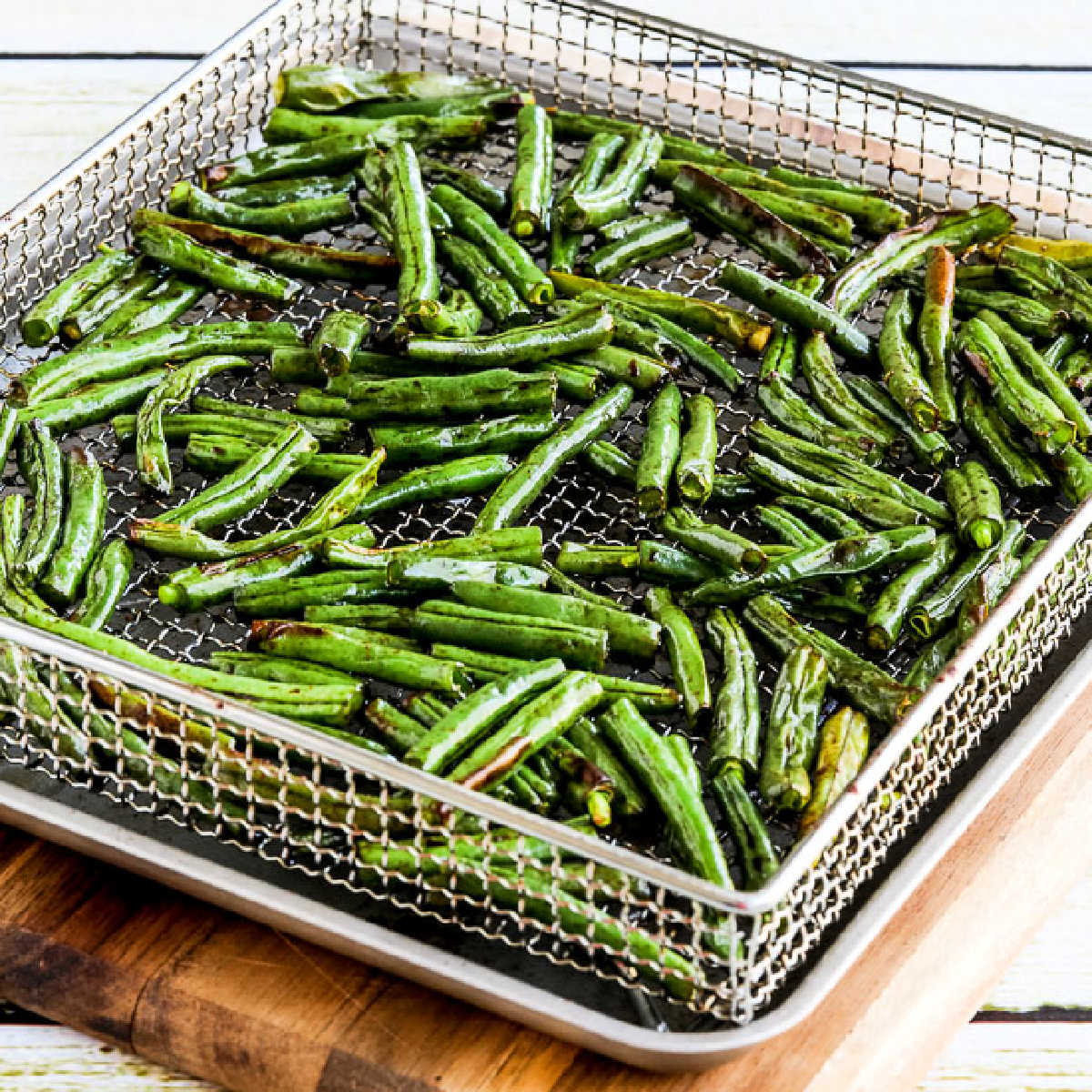 Square image of Air Fryer Asian Green Beans shown in Air Fryer basket.