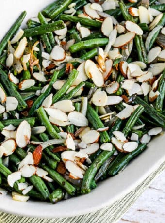 Garlic-Roasted Green Beans with Shallots and Almonds shown on serving plate