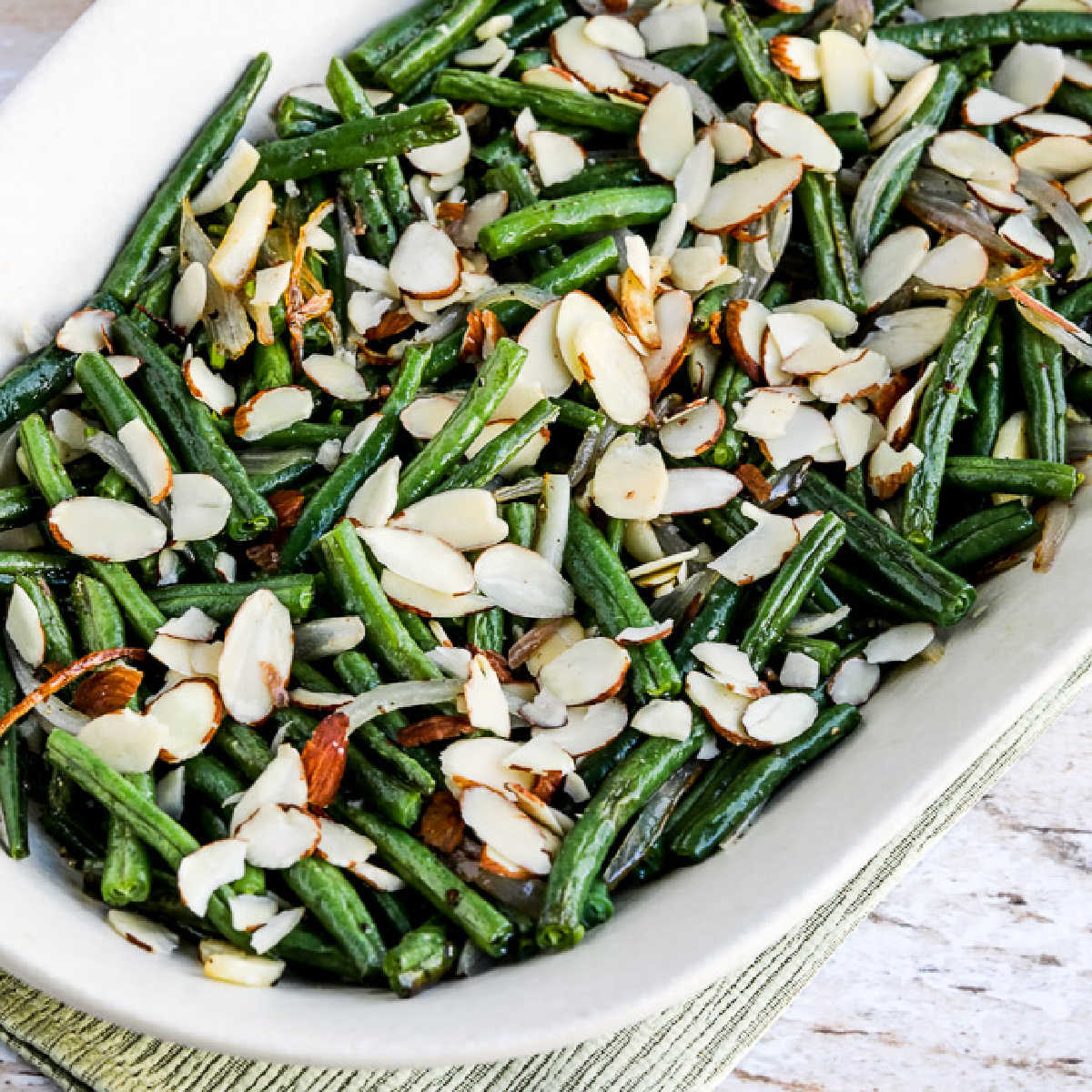 Garlic-Roasted Green Beans with Shallots and Almonds shown on serving platter