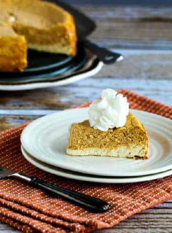 square image for Sugar-Free Layered Pumpkin Cheesecake on serving plate with cheesecake in background