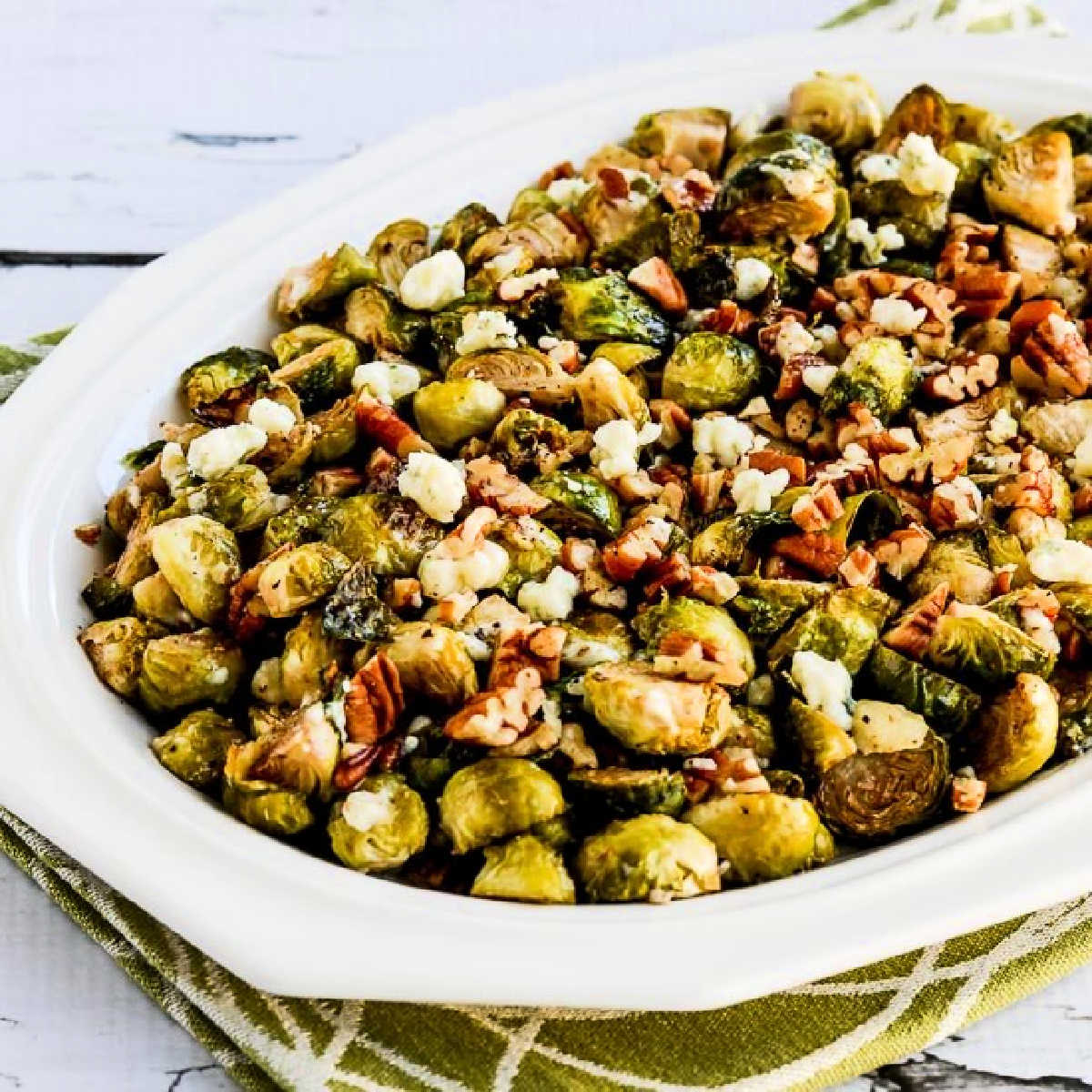 Square image for Roasted Brussels Sprouts with Pecans and Gorgonzola shown on serving plate.