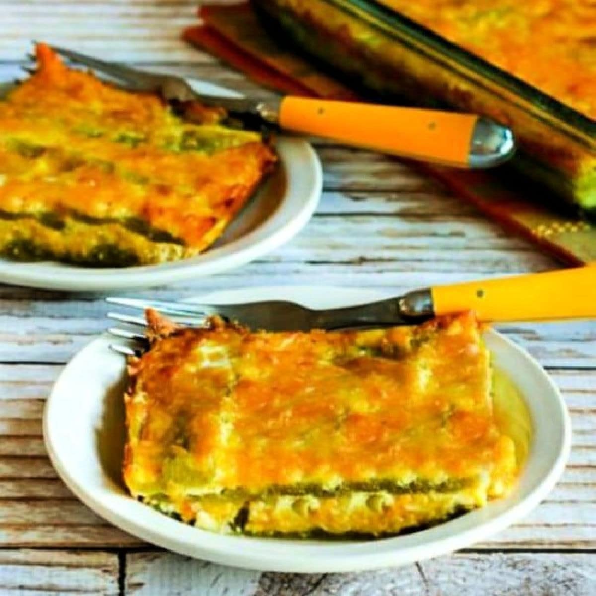 Square image of Chile Rellenos Bake on two plates with baking dishin back.