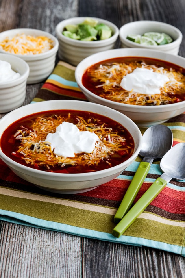 Instant Pot Taco Soup in two bowls with sour cream and cheese