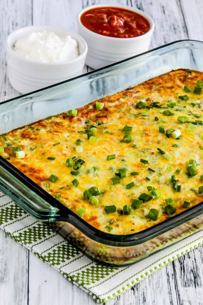 Southwest Egg Casserole shown in baking dish with sour cream and salsa