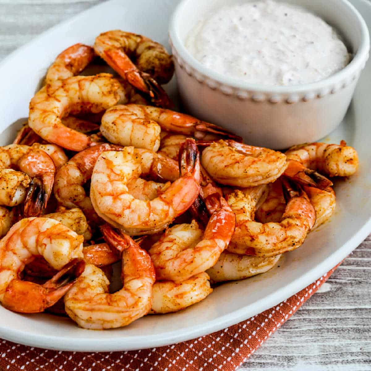 Air Fryer Shrimp shown on serving tray with sauce.