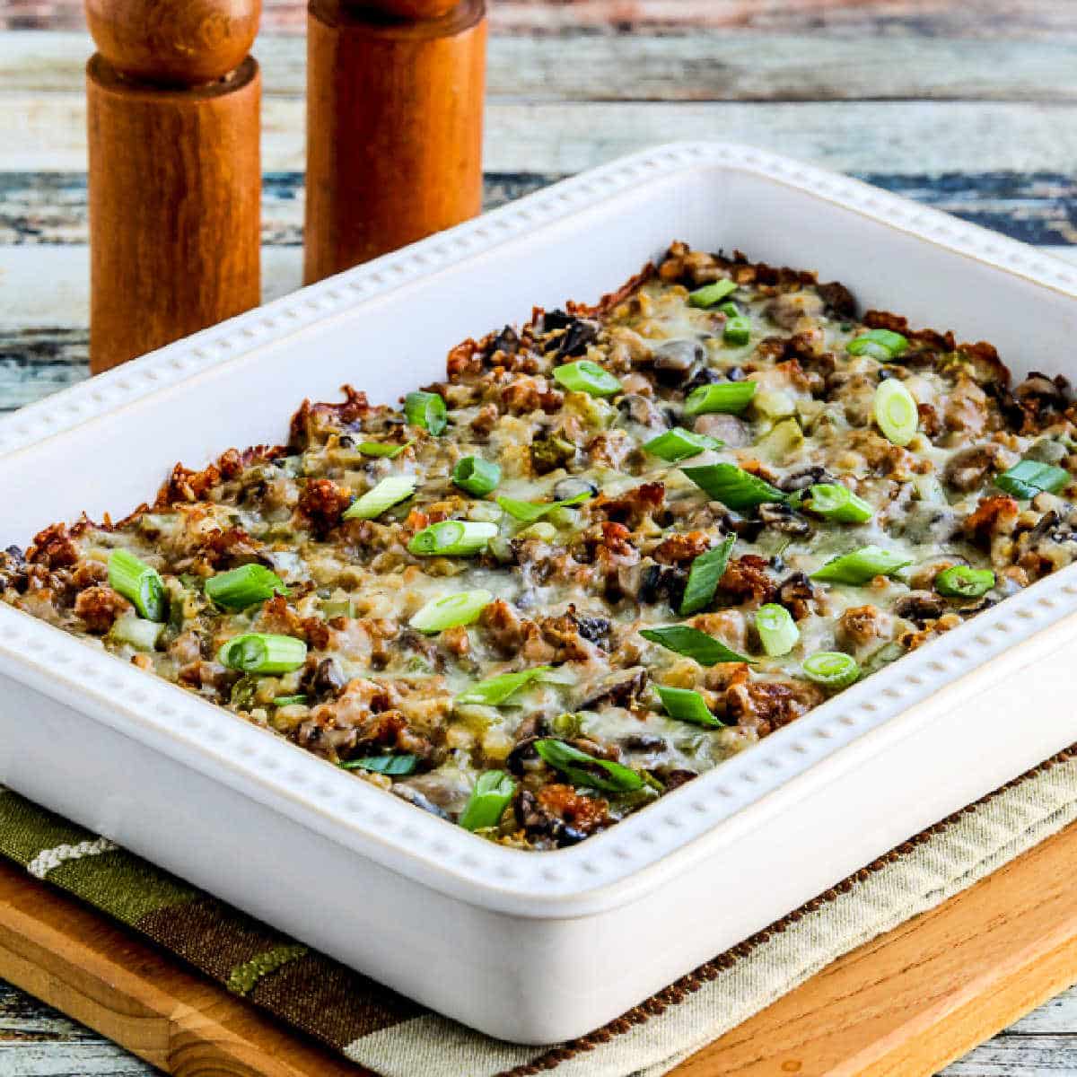 Square image for Cauliflower Rice Sausage Casserole shown in baking dish.