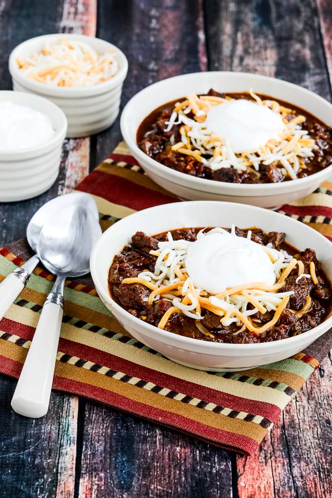 Instant Pot All Beef Ancho and Anaheim Chili in bowls with cheese and sour cream