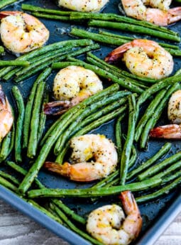 Square image for Spicy Green Beans and Shrimp Sheet Pan Meal shown on baking sheet.