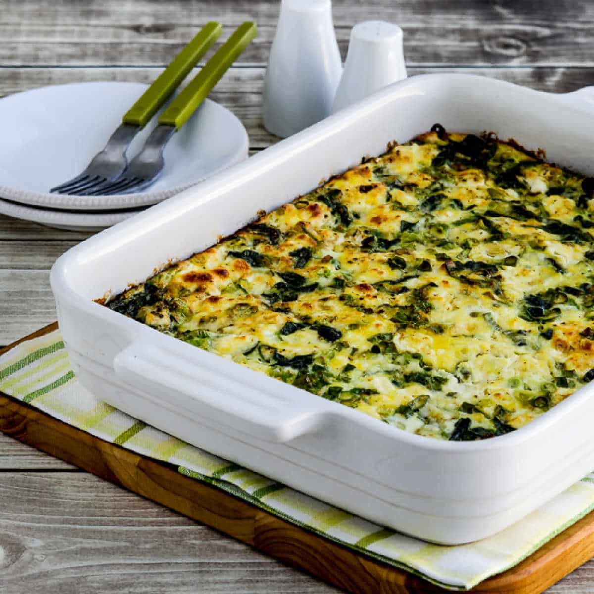 square image for Breakfast Casserole with Spinach and Goat Cheese shown in baking dish.