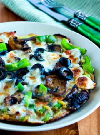square image for Egg-Crust Vegetarian Breakfast Pizza shown on plate with silverware