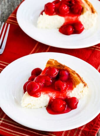 Square image of Low-Carb Cheesecake with Cherry Topping shown on two serving plates.