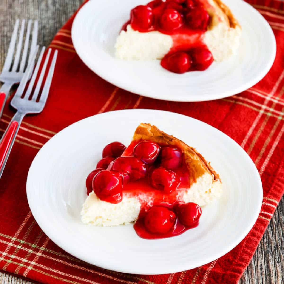Square image of Low-Carb Cheesecake with Cherry Topping shown on two serving plates.