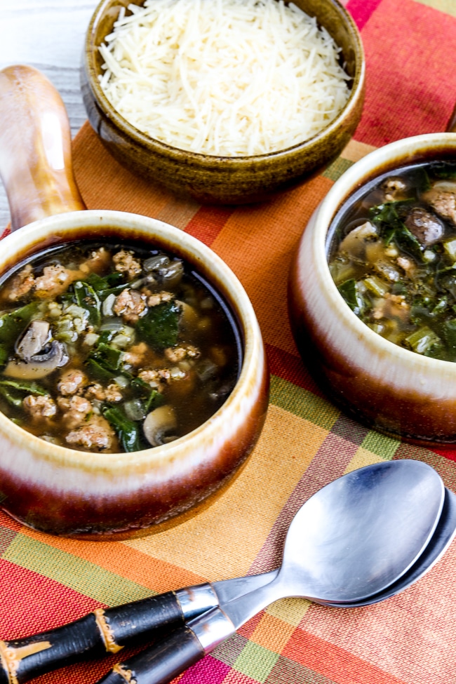 Updated Ground Turkey Soup Recipe with Mushrooms and Spinach, shown in two bowls with Parmesan.