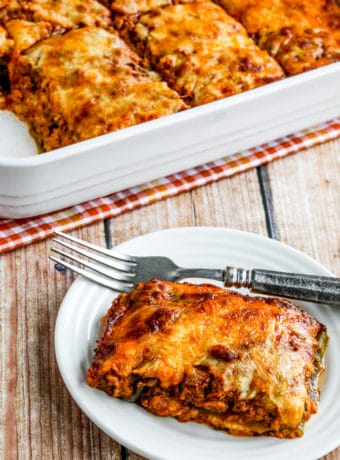 Low-Carb Turkey Enchilada Casserole one serving on plate and baking dish in background