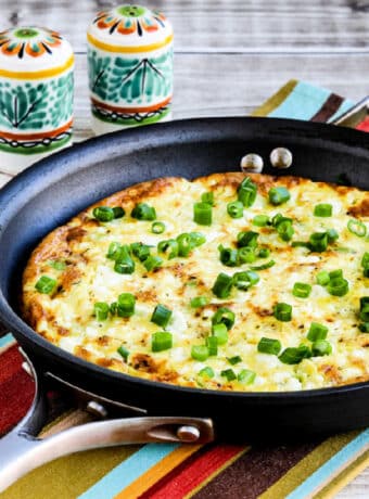 Square image for Feta Cheese Frittata with Avocado shown in pan on striped napkin.