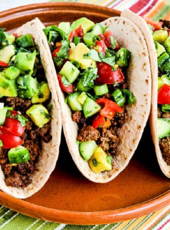 Ground Beef Tacos with Tomato-Avocado Salsa, square image of finished tacos on serving plate