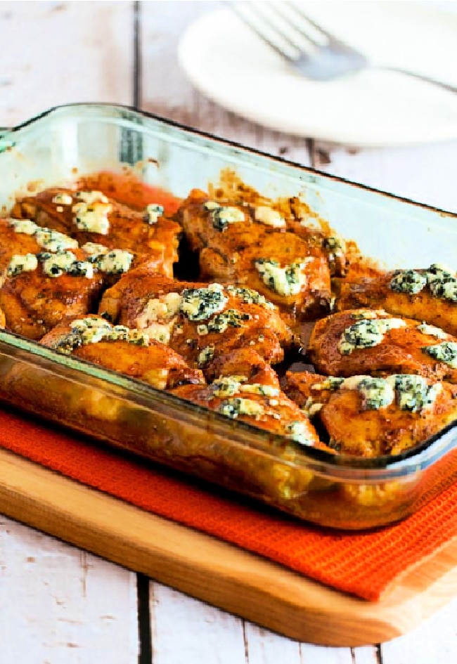Baked Buffalo Chicken with Melted Blue Cheese close-up photo of finished chicken in baking pan
