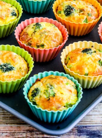 Square image of Breakfast Egg Muffin Recipe with Broccoli, Bacon, and Cheese shown on baking sheet.