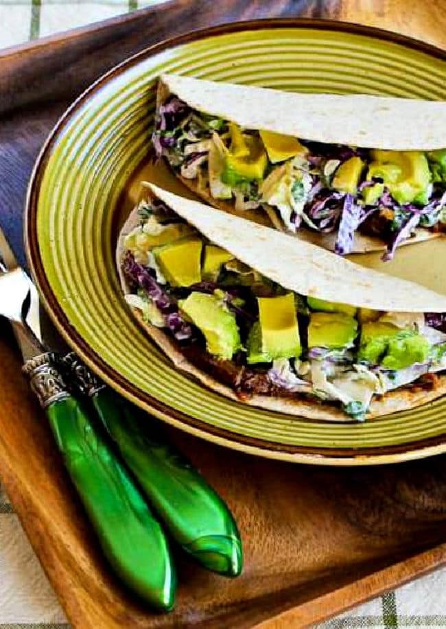 Shredded Beef Tacos with Spicy Slaw and Avocado shown on serving plate.