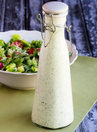 Square image for Cafe Rio Salad Dressing shown in bottle with salad in back.