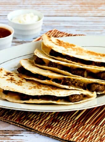 Square image of Sausage and Cheese Breakfast Quesadillas on serving plate.