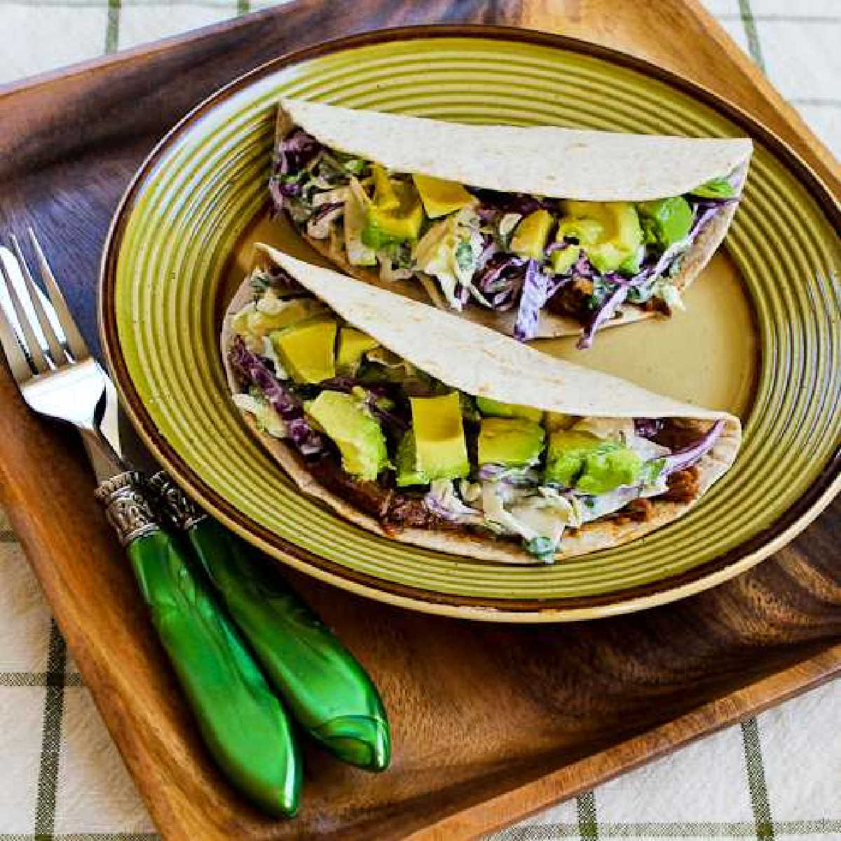 Square image for Shredded Beef Tacos with Spicy Slaw and Avocado shown on serving plate.