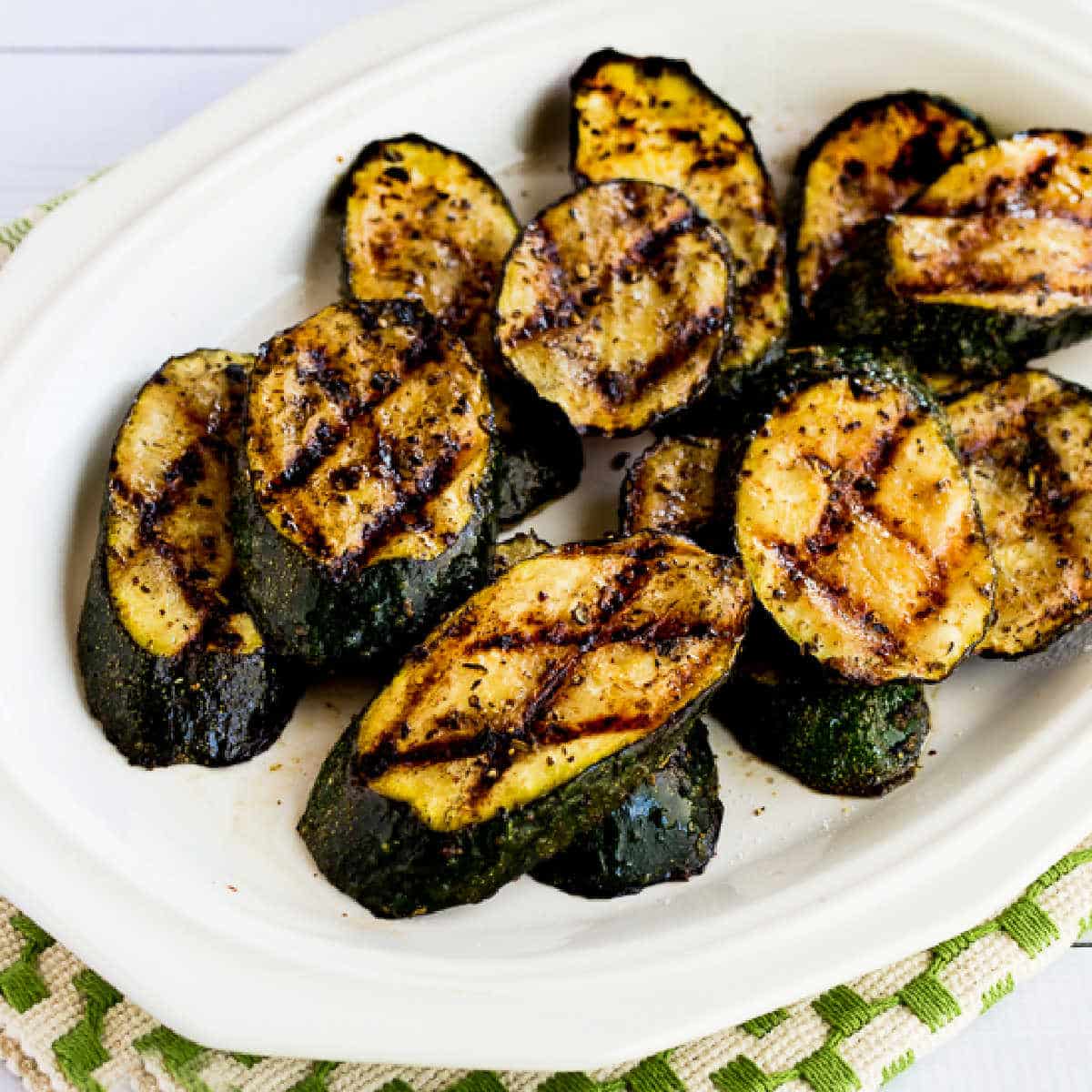 Square image for How to Grill Zucchini showing zucchini on serving plate.
