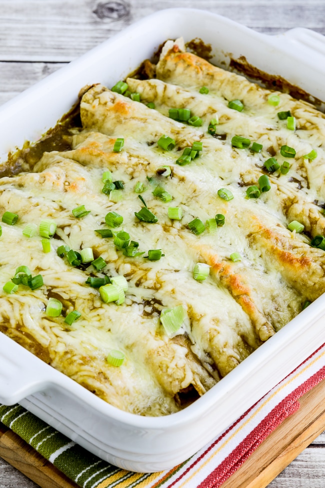 Instant Pot Green Chile Pork Enchiladas close-up of finished enchiladas in baking dish