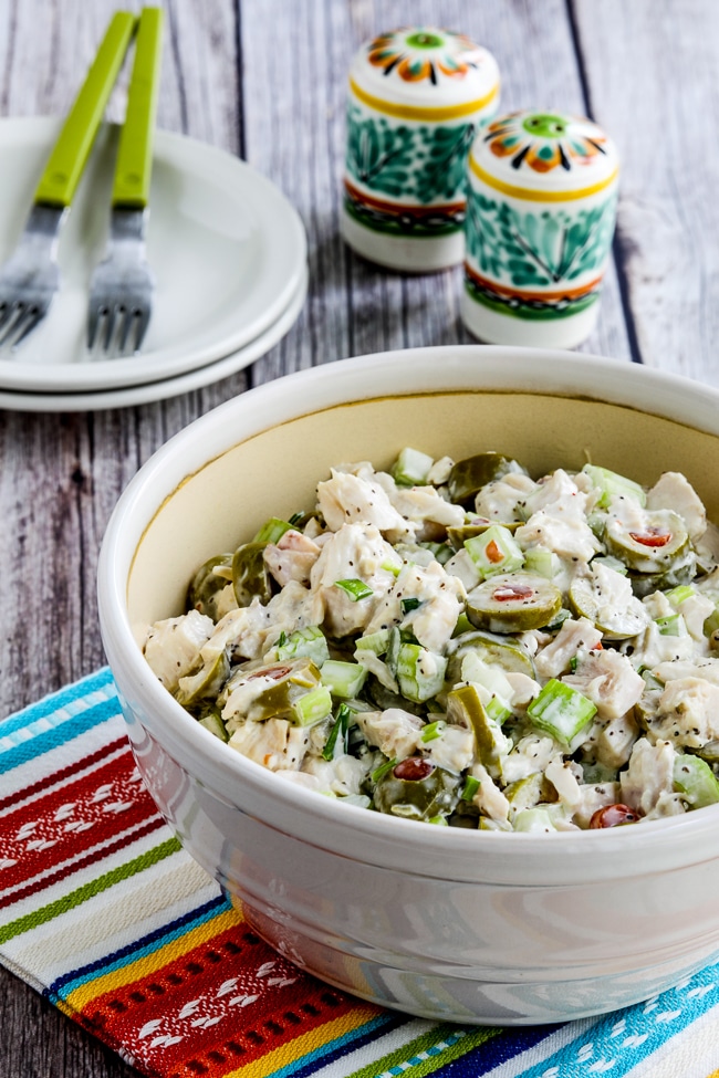 Chicken Salad with Green Olives in serving bowl with salt-pepper in back.